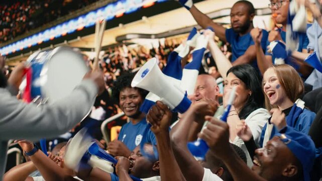 Passionate football capo beating drum and directing blue supporter group from stadium stands during coordinated chant at live soccer match, hardcore fans wave scarves, stadium chants.