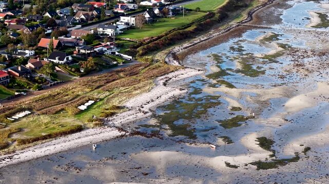 Low tide exposes riverbank in Jutland countryside, Denmark