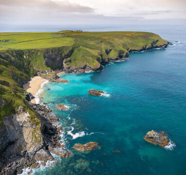 Aerial view of the rugged cliffs and turquoise waters at Hell's Mouth with a secluded sandy beach and rocky outcrops Camborne, England, United Kingdom.