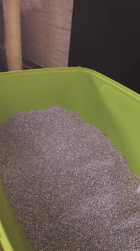 Person POV of preparing cat toilet sand with spatula