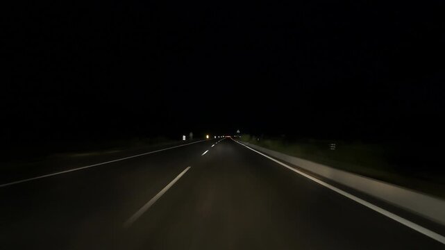 A high-speed shot at night captures the National Highway stretching from Upper to Lower Assam, where headlights trace glowing trails, revealing a dynamic rhythm of nocturnal travel. 4K