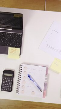 Clean and organized office table with laptop top view reveal