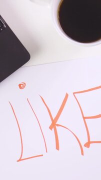 LIKE word with smile emoticon on empty paper office desk