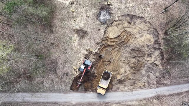 Heavy duty machine digging and moving soil outdoors