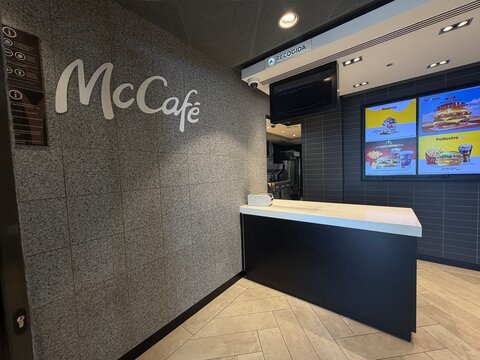 Mallorca, spain, june 20, 2026 mcdonald's mccafe counter and digital menu displays in a modern fast food restaurant interior, showing pickup area