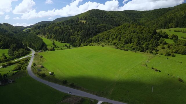 Aerial Drone View of a Scenic Road Through Forests, Meadows and Mountains near Cicmany in Slovakia