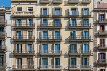 Obraz premium Barcelona Apartment Building Facade, Geometric Rows, Green Balconies, Urban Architecture Pattern