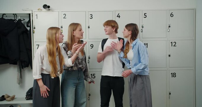 Teenage students having a disagreement by school lockers