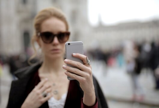 Young woman in sunglasses taking a selfie