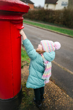 Child mailing Christmas wish list to Santa