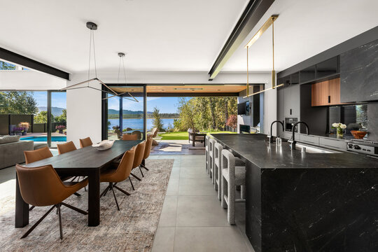 Modern luxury home kitchen with putting green, pool, and river view