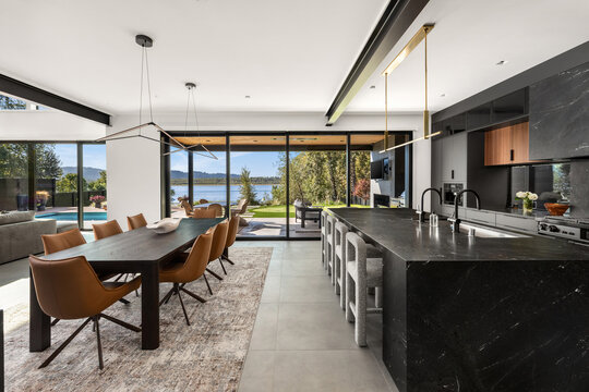 Sleek modern kitchen and dining area with lake view