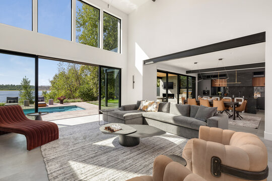 Luxury modern home living room and kitchen with pool and river view