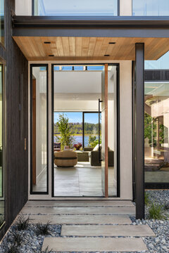 Modern home entryway opens to a stunning river view