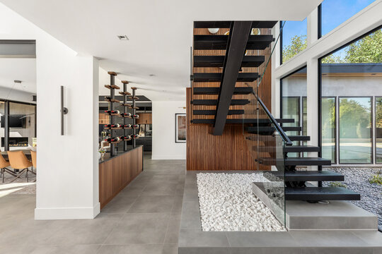 Stylish modern house with floating stairs and wine display