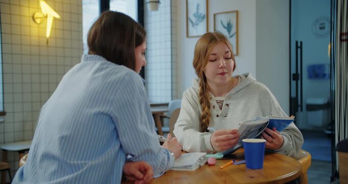 Students discussing homework assignment at classroom table