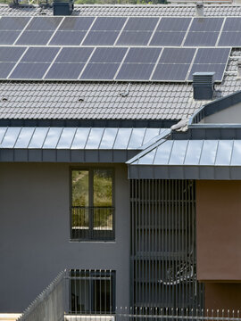 Aerial view of solar panels installed on a modern residential roof with grey metal tiles in Istanbul, Istanbul, Turkiye.