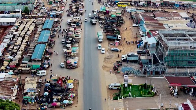 Rural kenya village market Africa poverty poor road infrastructure cars moving on the poor maintained roads in kenya