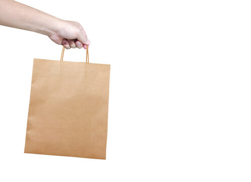 A man is holding an empty, medium-sized kraft paper bag PNG transparent.