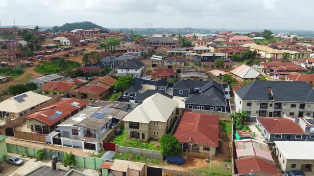 Aerial view of a dense residential neighborhood with various houses featuring metal roofs and walled compounds in Ibadan, Oyo, Nigeria.