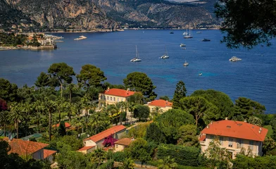 Aerial view of luxury villas on Saint Jean Cap Ferrat peninsula on the French Riviera, South of France, with boats on the Mediterranean Sea © SvetlanaSF