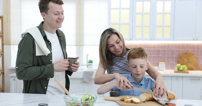 Family cooking together in kitchen, camera moving in and out