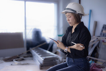 Female engineer is using a tablet and inspecting the work site