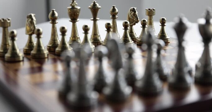 Chess pieces on game board, closeup. Camera refocusing