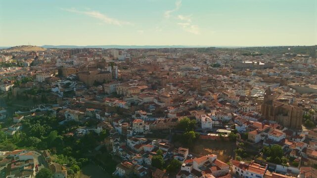 Backward drone flight above Caceres expanding view from the historic neighborhood outward to reveal the wider city.
