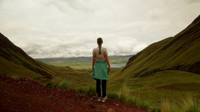 Female tourist enjoys stunning landscape views at Pallay Punchu Rainbow Mountain