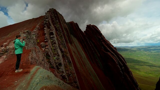 Female tourist captures scenic landscape on smartphone at Pallay Punchu