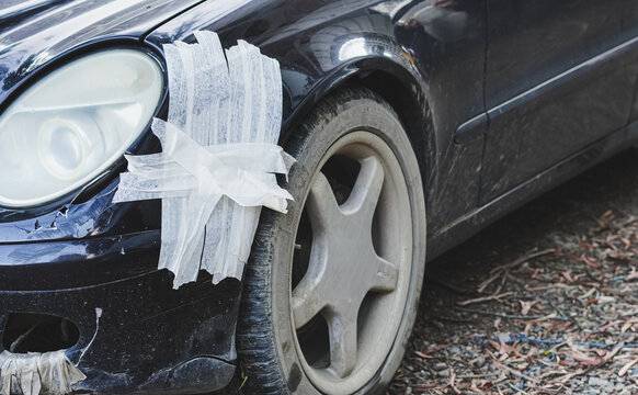 Taped up car part as a metaphor for fragile, temporary psychological coping fixes