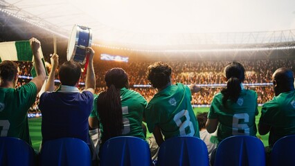 Football supporter beats drum among cheering fans during packed soccer match, soccer fan creating musical rhythm from stadium stands next to crowd chanting for football fan and match day concepts. © DC Studio