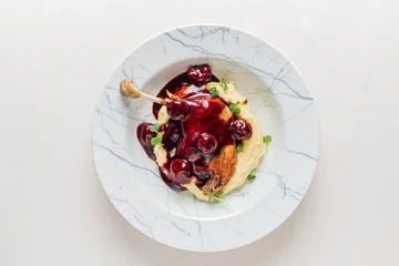 Delicious roasted chicken with cherry sauce served on creamy mashed potatoes © Maksim Shebeko