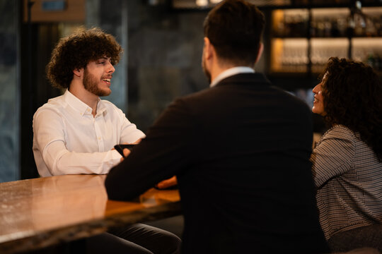 Employee having a job interview with recruiters at a bar