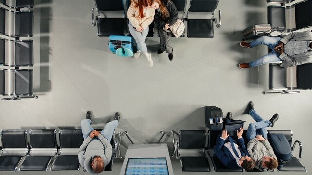 Rushing, looking at departure board screen and travelers in busy airport, top down view, Walking, flight timetable and tourists in terminal nest to people waiting for plane.