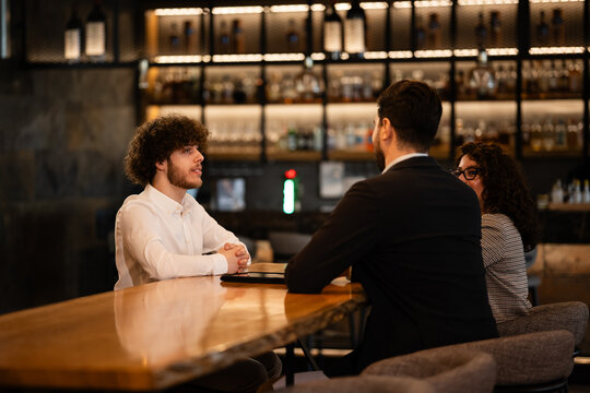 People having business conversation in a modern bar
