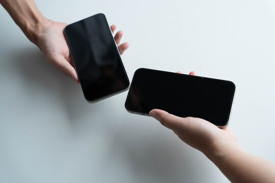 Man using smartphone close contect transfer file by wireless technology