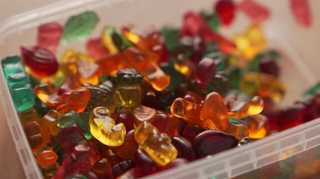 Marmalade candies of different colors in the form of animals, close-up. Gelatin candies.