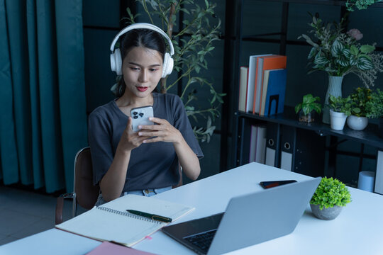 Beautiful woman wear headphone listen music on smarphone