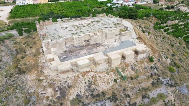 Aerial view of the Castillejo de Monteagudo Moorish fortress ruins located on a hilltop surrounded by agricultural fields in Murcia Spain showcasing medieval architectural heritage preservation