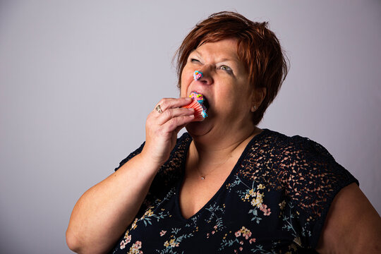 Stuffing face with a cupcake