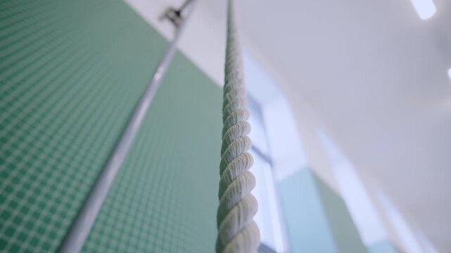 School gym features sturdy twisted cord for fitness training. Sports design provides professional and structured aesthetic for athletes