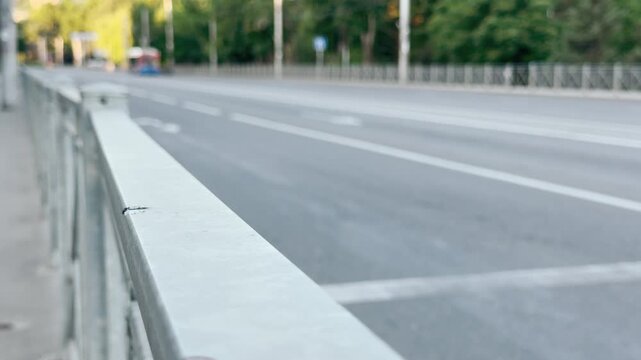 A metal railing lines an empty street in Simferopol, Crimea. This vast, quiet road creates a deeply peaceful yet lonely feeling on a bright morning.