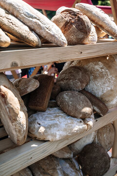 Fresh rustic sourdough loaves on a wooden shelf