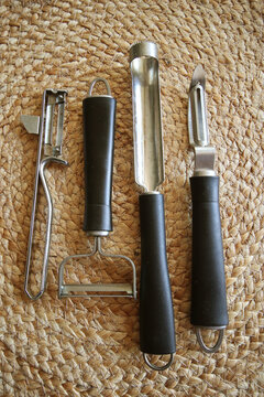 Kitchenware: stainless steel with serrated blade knives to peel and carve vegetables on natural background