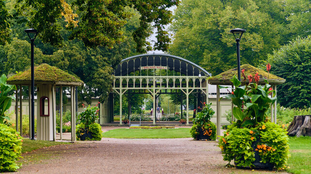 Ronneby, Blekinge County, Sweden - 11 September 2025: View of Brunssparken featuring the historic Brunnshallarna pavilion surrounded by lush gardens, green lawns, and mature trees.