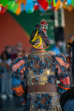 Rio de Janeiro, Brazil - 20 June 2026: View of a person wearing an elaborate, colorful costume adorned with flowers and trinkets during the Festa Junina festival.