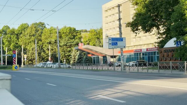A prominent road sign directs traffic to Sevastopol, Yalta, and Vorovskogo Street in Simferopol, Crimea. The large hotel and quiet street create a calm and peaceful morning mood.