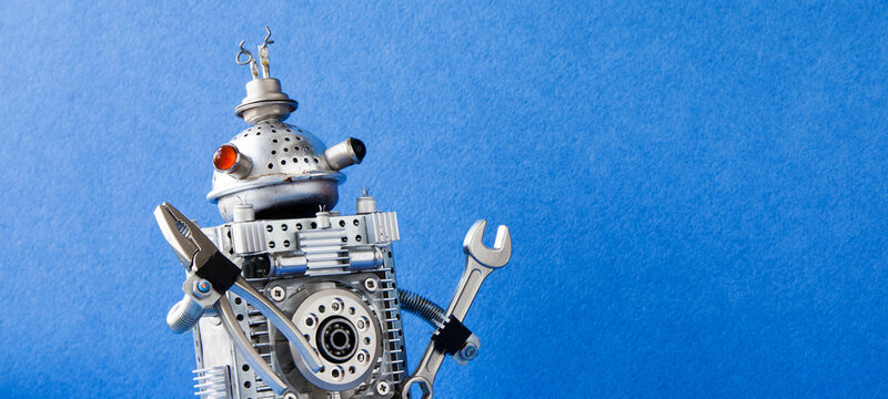 Unusual metallic robot handyman with multicolored eyes gripping pliers and wrench, blue backdrop text placeholder. Maintenance flyer, DIY leaflet, workshop invitation card